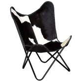 Fauteuil papillon en cuir de vachette véritable, assise et dossier rembourrés, structure en bois, style moderne et élégant.